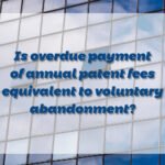 Is overdue payment of annual patent fees equivalent to voluntary abandonment?
